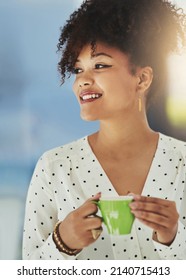 Optimism Is Key In Setting Up A New Business. Cropped Shot Of A Young Designer Having Coffee In Her Office.