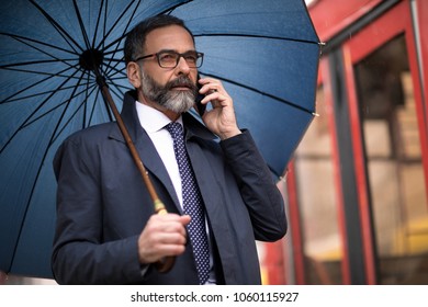 Business Man Walking In The Rain Stock Photos Images