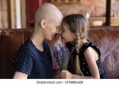 Optimistic Cancer Patient Spending Time With Family. Little Daughter Giving Flowers To Ill Mom, Celebrating Birthday, Congratulating On Mothers Day, Hugging, Touching Faces And Noses. Oncology Concept