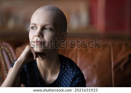 Optimistic cancer patient thinking of treatment recovery, remission after successful chemotherapy. Young woman fighting against oncology disease. Leukemia survivor, breast cancer fighter portrait