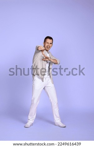 optimistic caucasian young man pointing finger on camera