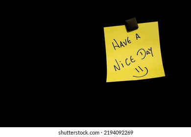 Optimistic Note On Yellow Post-it Paper On Black Bulletin Board - Have A Nice Day