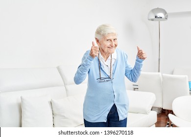 Optimistic old woman holds the thumbs up full of joy and vitality - Shutterstock ID 1396270118
