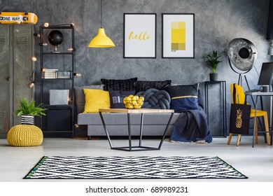 Optimistic teenager's room with gray wall, furniture and yellow accents