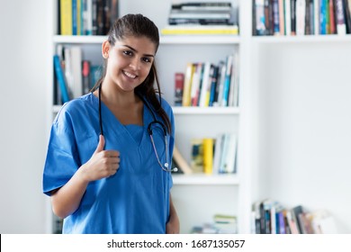 Optimistic young adult spanish female nurse or medical student at hospital