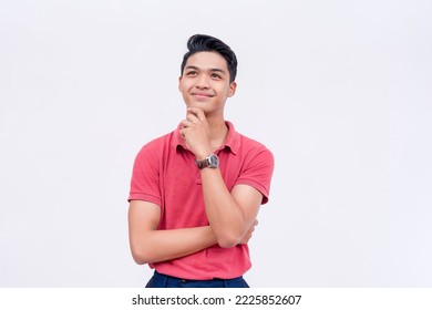 An optimistic young man thinking.Visualizing a happy future. Thinking of sound strategies. Isolated on a white background.