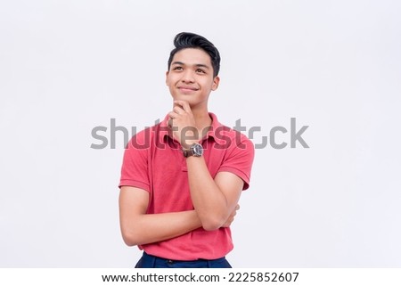 An optimistic young man thinking.Visualizing a happy future. Thinking of sound strategies. Isolated on a white background.