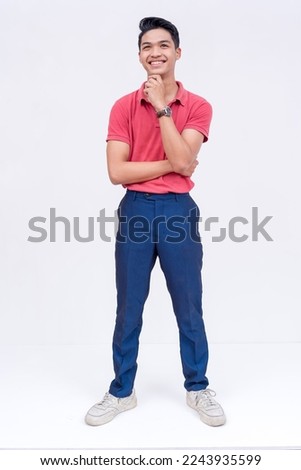 An optimistic young man thinking.Visualizing a happy future. Thinking of sound strategies. Isolated on a white background.