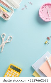 Optimize your learning experience with vertical top shot featuring diverse assortment of school supplies, calculator and mini clock on blue isolated backdrop. Utilize empty circle for text or adverts