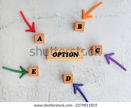 Options A, B, C, D, E written on 
wooden cubes with colorful arrows 