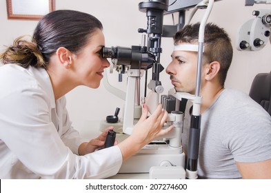 Optometrist chair and slit lamp, ophtalmology diopters calibration in oculist lab of young woman doctor with young latin lamp. - Powered by Shutterstock