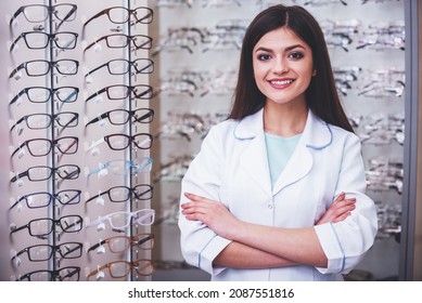 Optometrist is looking at the camera in glasses store. Professional young worker woman. - Shutterstock ID 2087551816