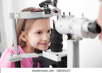 Optometrist performing visual field test of young girl
