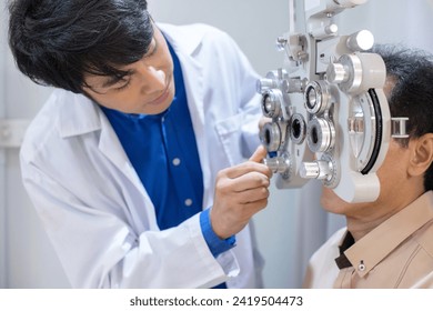 Optometrist uses ophthalmological diagnostic equipment to test the vision of an elderly man, diagnostic ophthalmology equipment, selective focus - Powered by Shutterstock