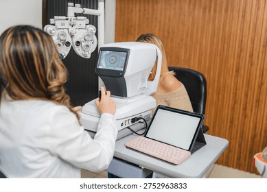 Optometrist using an autorefractor to perform a precise eye exam on a female patient, ensuring her visual health and providing accurate vision assessment in a modern optics clinic