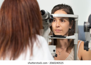 Optometrist Woman Examining The Eyesight Of Another Woman With A Slit Lamp