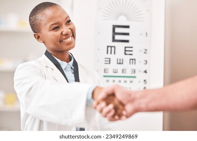 Optometrist woman, handshake and smile with patient, customer and happy for agreement, deal or sale. African ophthalmology doctor, shaking hands and kindness for healthy eyes, wellness or healthcare - Powered by Shutterstock