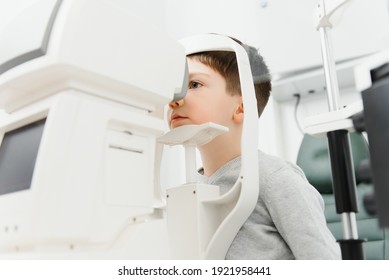 Optometry concept. Female optometrist optician doctor examines eyesight of child boy in eye ophthalmological clinic
