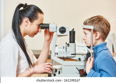 Optometry Concept. Female Optometrist Optician Doctor Examines Eyesight Of Child Boy In Eye Ophthalmological Clinic 