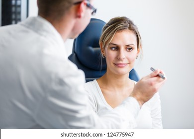 Optometry Concept - Pretty Young Woman Having Her Eyes Examined By An Eye Doctor/optometrist (color Toned Image; Shallow DOF)