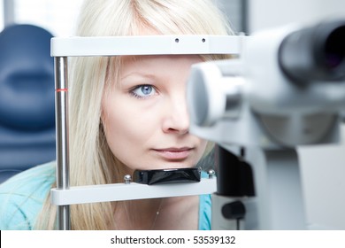 Optometry Concept - Pretty Young Woman Having Her Eyes Examined By An Eye Doctor On A Slit Lamp