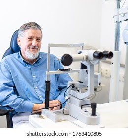 Optometry Concept - Senior Patient Sitting The Exmanination Chair , Before Having His Eyes Examined By An Eye Doctor, Smiling, Looking Happy