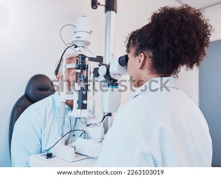 Optometry, eye exam and ophthalmologist testing patient vision or eyes using a slit lamp machine by a doctor. Healthcare, eyecare and medical insurance professional doing a visual examination on man