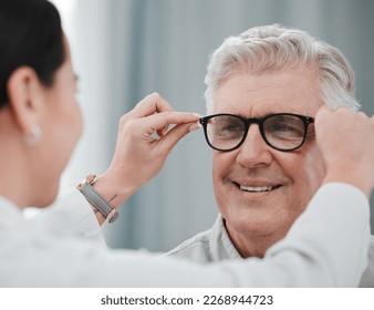 Optometry, ophthalmology and optometrist fitting glasses on senior man patient or happy client during appointment. Doctor, consultation and eyewear or spectacles for an elderly male for vision - Powered by Shutterstock