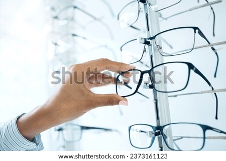 Optometry store, glasses and hands of person for lens frame decision, retail shop choice or eyewear sales. Eye care clinic, vision eyesight support and closeup client, customer and choose eyeglasses