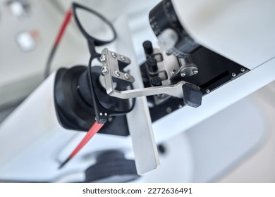 Optometry, vision and a lens meter in a clinic to measure or adjust the level of eyesight improvement from above. Glasses, eyewear and machine for prescription frame spectacles in a medical office