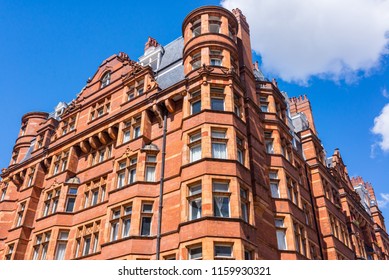 Opulent British Victorian terraced luxury residential building in red bricks in Mayfair, London, UK