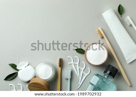 Oral care accessories on gray background, space for text