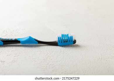 Oral care. Toothbrushes on a gray cement background. The concept of cosmetic products for the bathroom. Flat lay, top view, copy space. Oral care products set. Dental hygiene - Shutterstock ID 2175247229