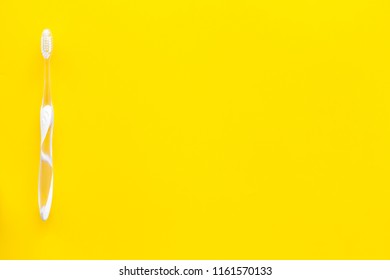 Oral Hygeine. Toothbrushes On Yellow Background Top View Copy Space