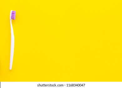 Oral Hygeine. Toothbrushes On Yellow Background Top View Copy Space