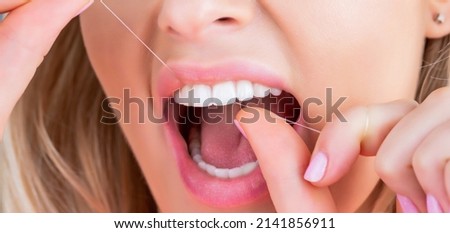 Oral hygiene and health care. Smiling women use dental floss white healthy teeth. Dental flush - woman flossing teeth. Dental floss. Taking care of teeth. Healthy teeth concept. Teeths Flossing.