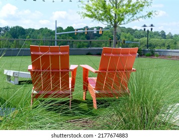 Orange Adirondack Chairs In Park