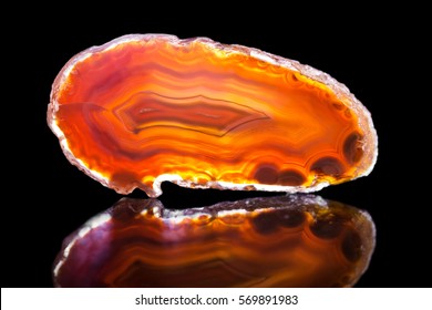 Orange Agate Slice, Black Background, Healing Stone And Mineral, Reflection