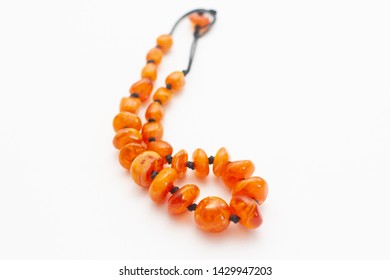 orange amber beads necklace jewelry on white background