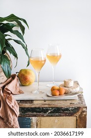 Orange Or Amber Wine In Glasses, Fruits And Cheese