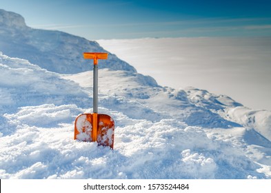 Orange Avalanche Shovel In Powder Fresh Snow And Place For Writing Text..