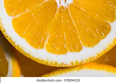 Orange Background From Slice Of An Orange Fruit Texture.