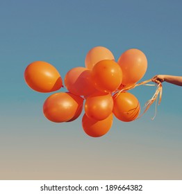 orange balloons on blue sky