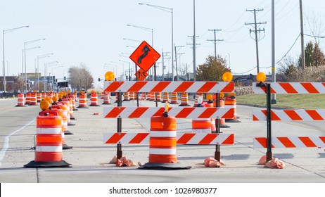 Orange barrels, barricades, and signs blocking a road - Shutterstock ID 1026980377