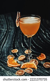 Orange Base Cocktail With Dried Orange As Garnish