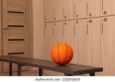 Orange Basketball Ball On Wooden Bench In Locker Room