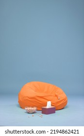 Orange Bean Bag With Sky Blue Limbo Background. Tissue And Popcorn Included.