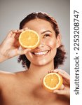 Orange, beauty and woman face in studio with a smile for natural skin glow, cosmetic and dermatology. Facial results, health and wellness of aesthetic model person happy with vitamin c fruit idea