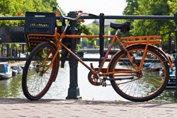 Orange Bike And The Canals Of Amsterdam