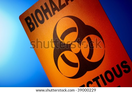 Orange bio hazard sign dramatically shot in front of glowing blue background